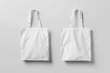 Two blank white tote bags on gray background. (5)