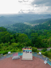 Aerial drone view of  mountain viewpoint surrounded with greenery rainforest at Wang Kelian, Perlis, Malaysia.
