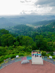 Aerial drone view of  mountain viewpoint surrounded with greenery rainforest at Wang Kelian, Perlis, Malaysia.