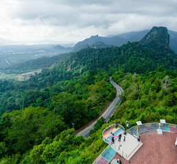 Aerial drone view of  mountain viewpoint surrounded with greenery rainforest at Wang Kelian, Perlis, Malaysia.
