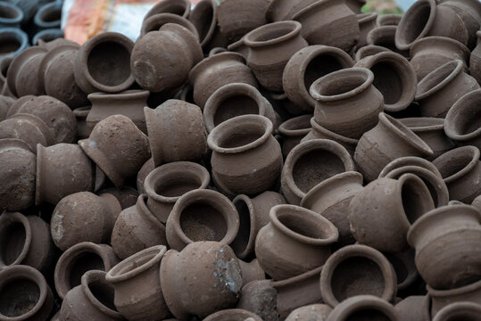 Hands of a potter at work. Potter making ceramic mug on the pottery wheel