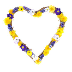 Heart shape floral wreath with Spring flowers on white. Symbol of love for Beltane festival, Valentines Day, Mothers Day, birthday, wedding or anniversary greeting card.l