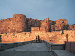 Agra Fort - Historic red sandstone fort of medieval India at sunrise. Agra Fort is a UNESCO World Heritage site in the city of Agra India. Walls of the ancient Red Fort in Agra