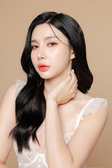 Fototapeta premium Young Asian beauty woman long hair in white lingerie with korean makeup style on face and perfect skin on isolated beige background. Facial treatment, Cosmetology, plastic surgery.