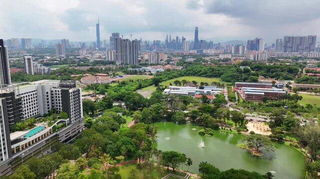 Arial footage flying over Taman Tasik Permaisuri looking at Kuala Lumpur skyscrapers.