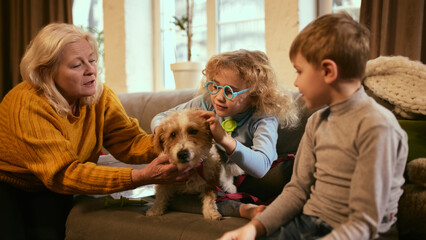Grandmother helping children understand health care by checking dog, teamwork fosters early...