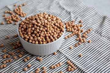 Dry Organic Chickpeas in a Bowl, side view. Copy space.