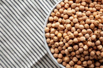 Dry Organic Chickpeas in a Bowl, top view. Flat lay. overhead, from above. Copy space.