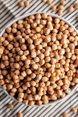 Dry Organic Chickpeas in a Bowl, top view. Flat lay. overhead, from above.