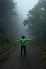 man walking in the fog forest