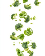 Fresh broccoli florets falling on white background.