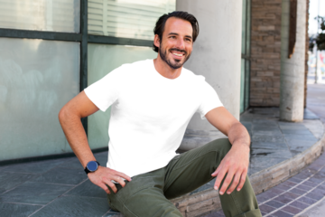 Png men's tee apparel mockup on a man sitting on the steps  street style fashion