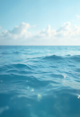Obraz premium blue surface of ocean water close up, low angle, against background of sky and white clouds, impressive seascape, beautiful and calm water surface