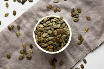 Healthy Raw Organic Pumpkin Pepita Seeds in a Bowl, top view.