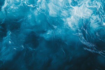 Calm ocean water with rippling waves reflecting sunlight in serene blue shades