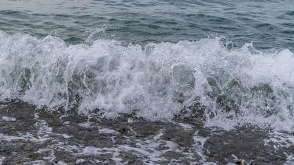 Water sea beach. Wave ocean blue. Stone texture reflection sun. Surface coast pebbles. 