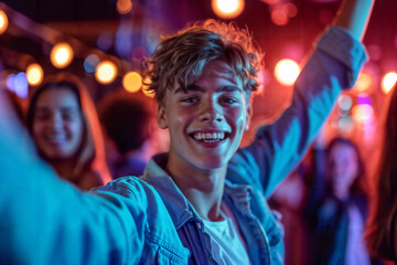 Obraz premium Boy Enjoys Dancing With Friends in a Lively Club Environment