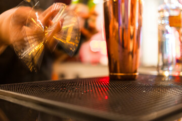 Barman preparing cocktail for celebrating holiday party at restaurant bar.