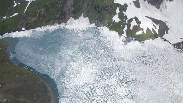 A serene aerial view of Chitta Katha Lake surrounded by snow in Neelum Valley, Pakistan