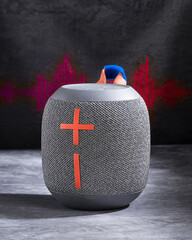 portable Bluetooth speaker with a textured fabric finish, offering superior audio quality and seamless wireless connectivity. Perfect for music lovers and on-the-go entertainment.