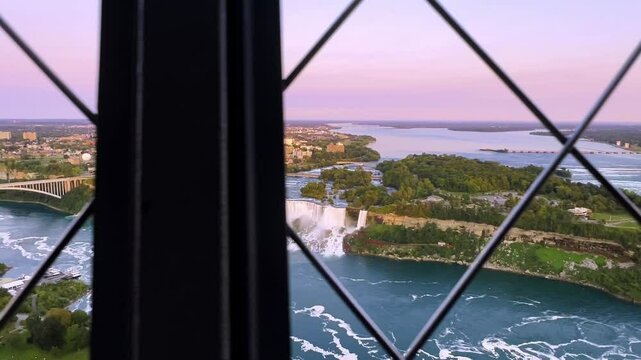 Scenic walk along the circular Skylon Tower, overlooking a vibrant Canadian cityscape at sunset with lush greenery and urban highlight, Canada