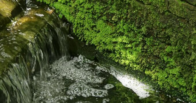 Crystal-clear waters falling into a catchment of a reservoir for an irrigation system.