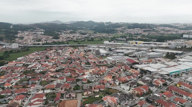 Aerial - Alfena village with red rooftops and industrial areas, Valongo, Portugal