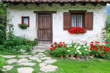 Charming Rustic Cottage Surrounded by Vibrant Flower Gardens in Nature