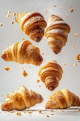 Freshly baked croissants tumbling isolated on white background 