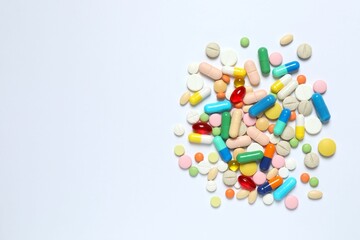 Various pills on white background