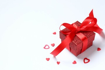 Beautiful gift box with red hearts on white background