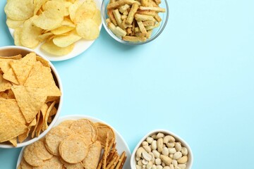 Various unhealthy snacks on color background
