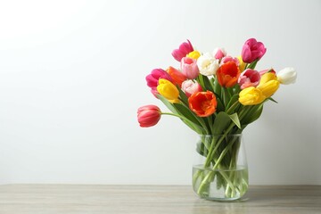 Beautiful fresh tulips in a vase on the table