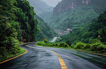 Winding road through lush green mountain valley after rain.