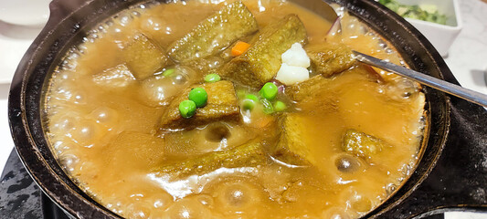 Rustic Vegetable Stew in a Hot Stone Pot with Colorful Ingredients