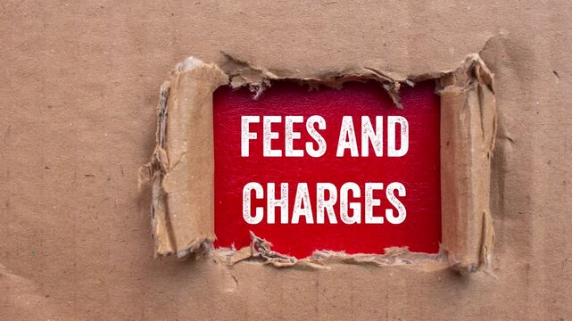 Fees and charges message writing on ripped torn cardboard paper on red background