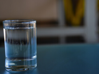 A glass of water for drinking is placed on the dining table.
