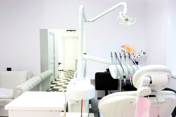 Dental office with a patient chair and medical equipment for dental treatment.