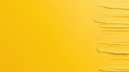 Fototapeta premium Bright yellow background with textured paint strokes on one side.