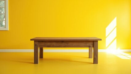 Simple wooden table against a vibrant yellow wall in a sunlit room