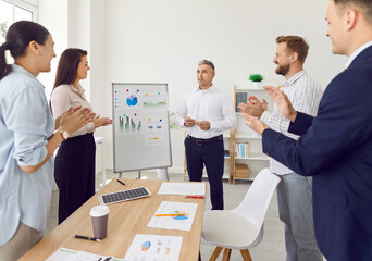 Businessman leads a meeting or presentation for a group of colleagues in the office. People team collaborates on work related tasks, emphasizing the importance of teamwork and effective communication.