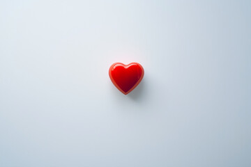 Fototapeta premium A sleek white background with a single red heart outline in the center