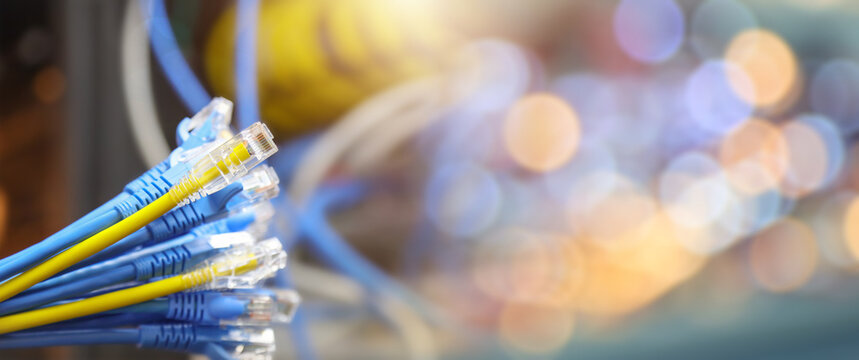 A Lot of LAN internet network cable or RJ45 UTP Cat6 fiber optic Ethernet cables for computer data link Wi-Fi connect cloud computing server networking devices system switch or hub router technology.