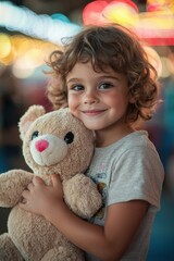 Child enjoys carnival atmosphere while hugging a teddy bear during colorful evening festival