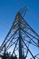 National grid electricity pylon in close up. Electricity network and power distribution. 