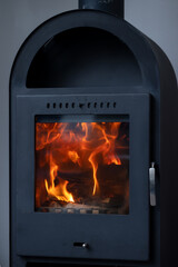 Wood burning in the fireplace. A beautiful flame. Heat
