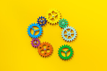 Colorful gears are connected together as a symbol of teamwork and business automation