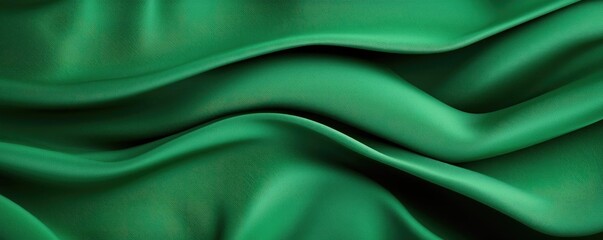 Obraz premium Velvet abstract background concept. Smooth green fabric waves create a luxurious and elegant background texture.