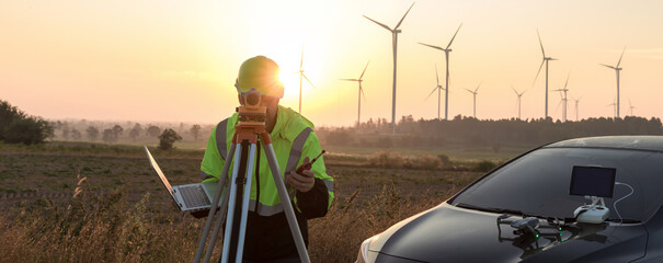 Survey Team Alternative energy for future. Engineers survey and checking wind turbines in sunset....