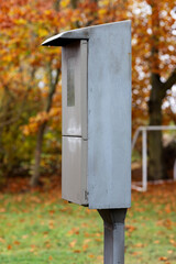Electricity meter in a metal cabinet on the side close-up